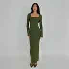 Woman wearing a green knit lounge corset dress against a plain background