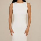 White sleeveless lounge dress worn by a person on a beige background
